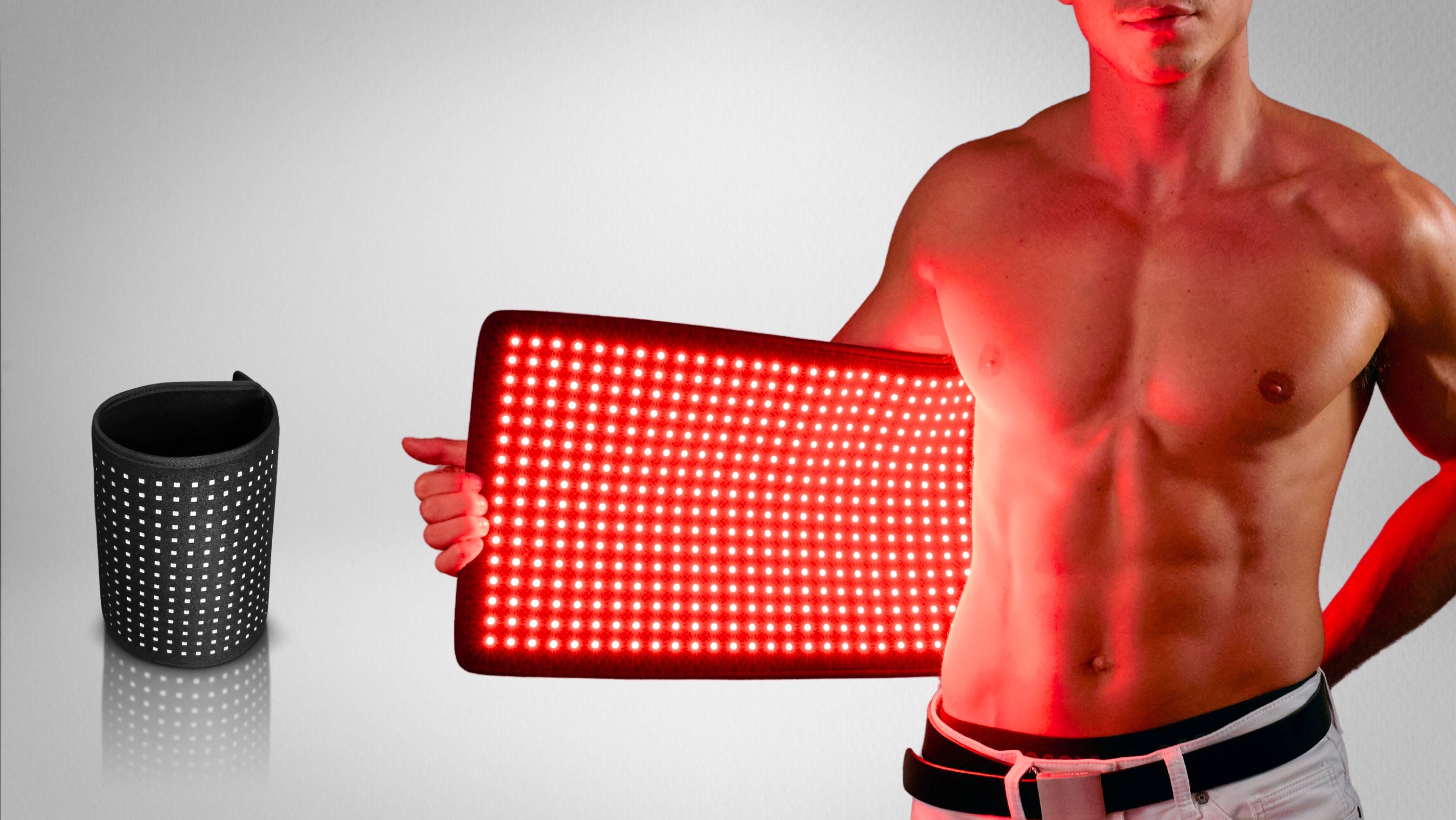 A shirtless man holds a glowing red light therapy pad, with a rolled-up version shown beside him.