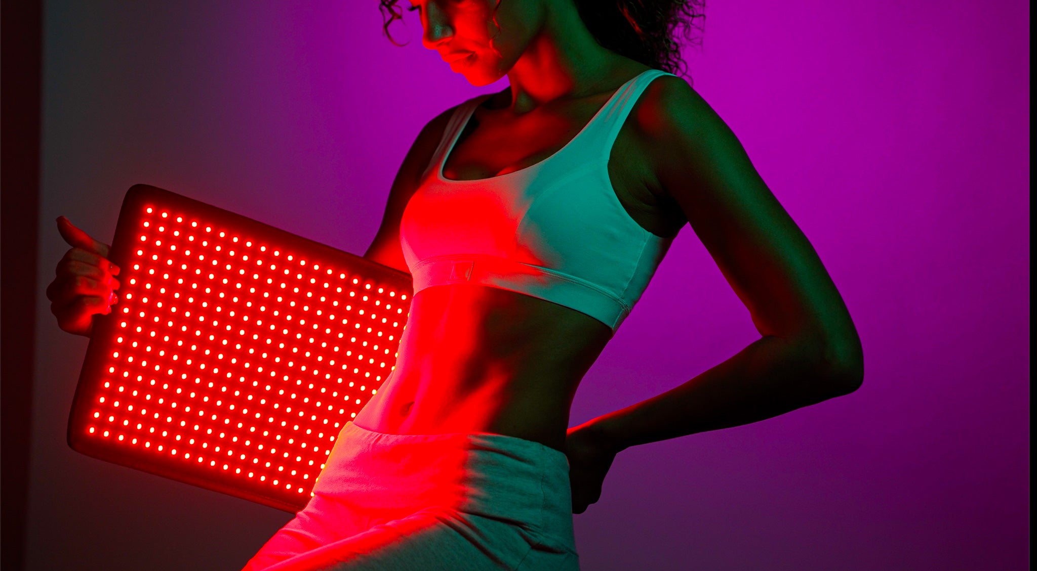 A lady using Lumara Pad Red Light Therapy